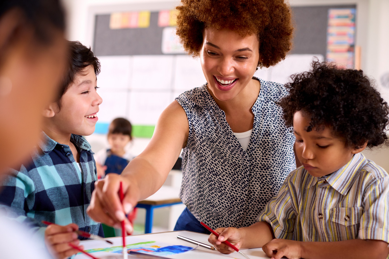 children happily learning with a teacher