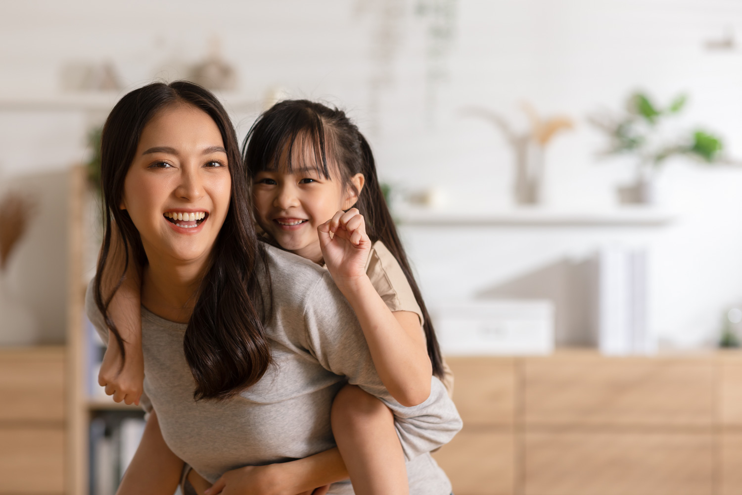 asian child and mother smiling together