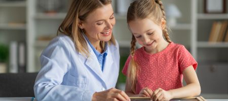 child playing learning game with therapist