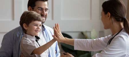 child high-fiving with therapist