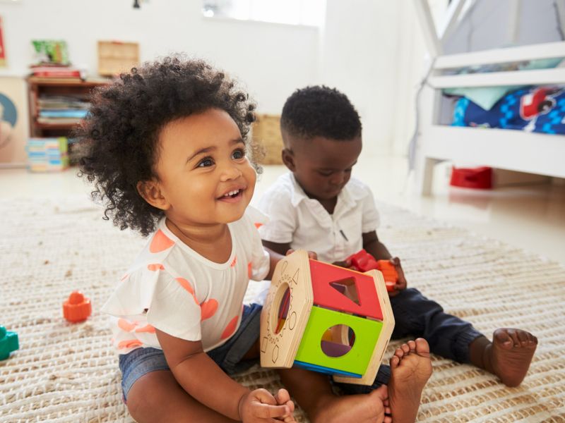 toddler siblings playing together